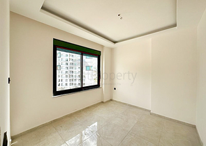 1+1 Wohnung in einem im Bau befindlichen Haus im Stadtteil Mahmutlar