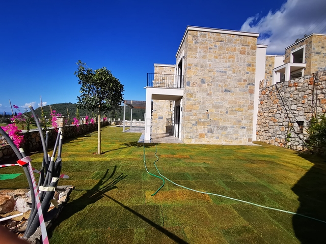 Villen in der malerischen Gegend von Turkbükü, umgeben von dichtem Grün. 